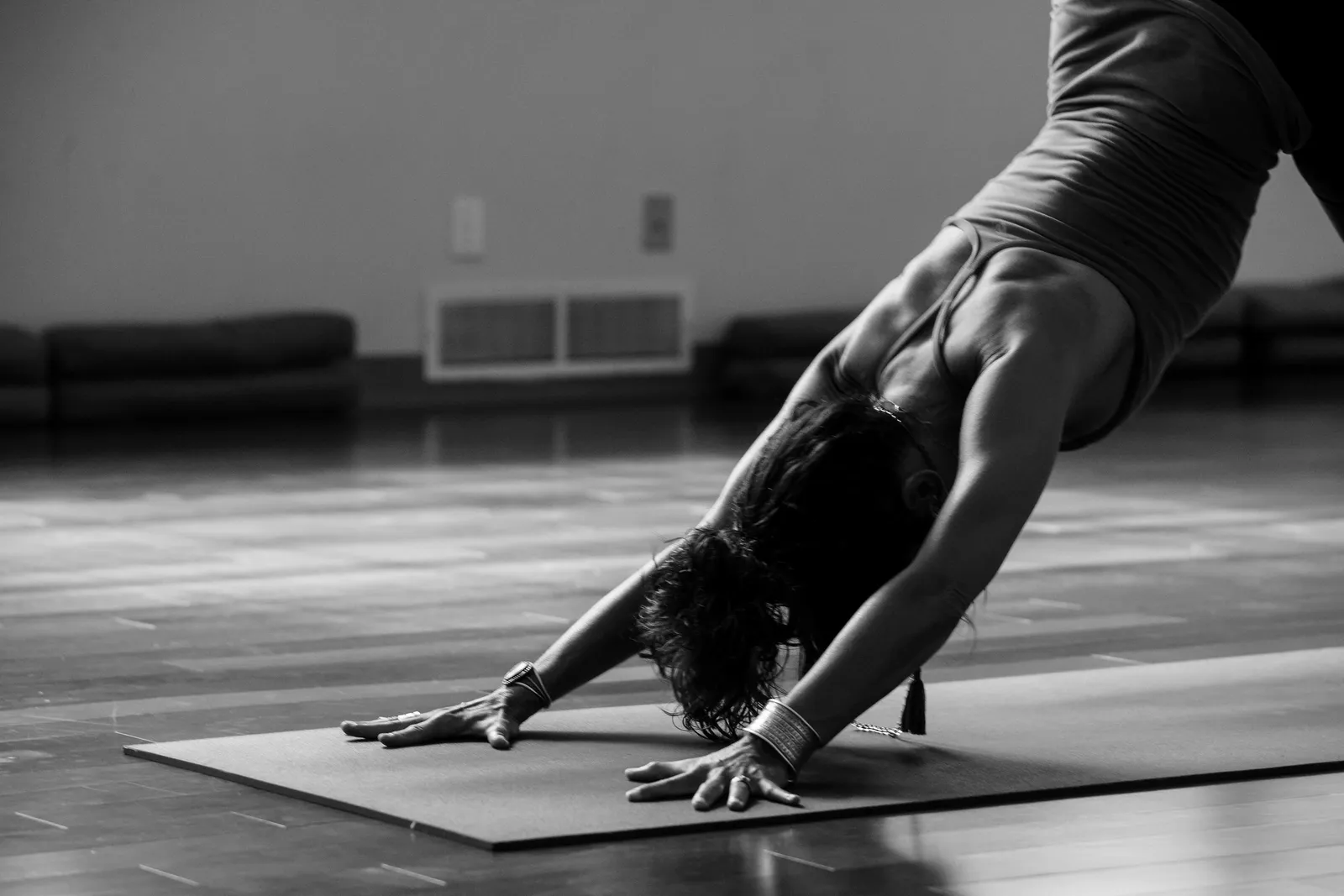 A flowing yoga practice in a warm, wood-floored studio